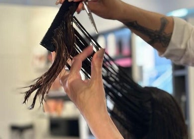 Stylist expertly cutting hair at Leo & Simon Salon, Windsor, England, GB. Experience professional salon services.