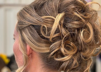 Elegant updo hairstyle at Leo & Simon Salon, Windsor, England, GB. Perfect for special occasions.