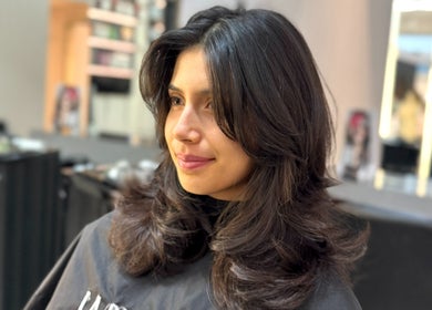 A woman with styled hair at Leo & Simon Salon, Windsor, England, GB, showcasing a fresh look.