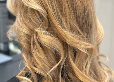 Golden curls styled at Leo & Simon Salon, Windsor, England, GB. Perfect luxurious hair finish.
