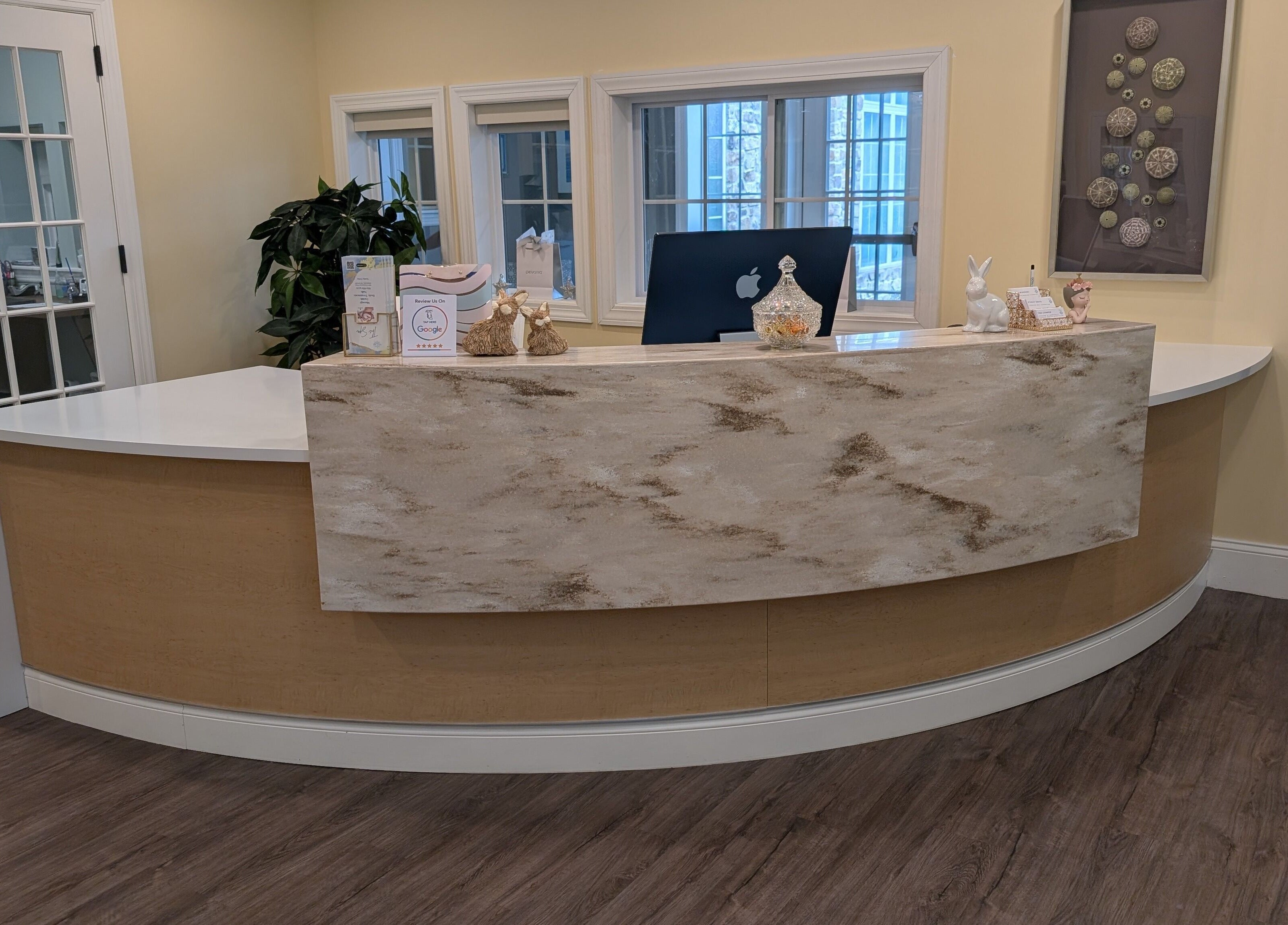 Reception desk at The Spa at The Villas Holmdel, Holmdel, New Jersey, US, welcoming guests with cozy decor.