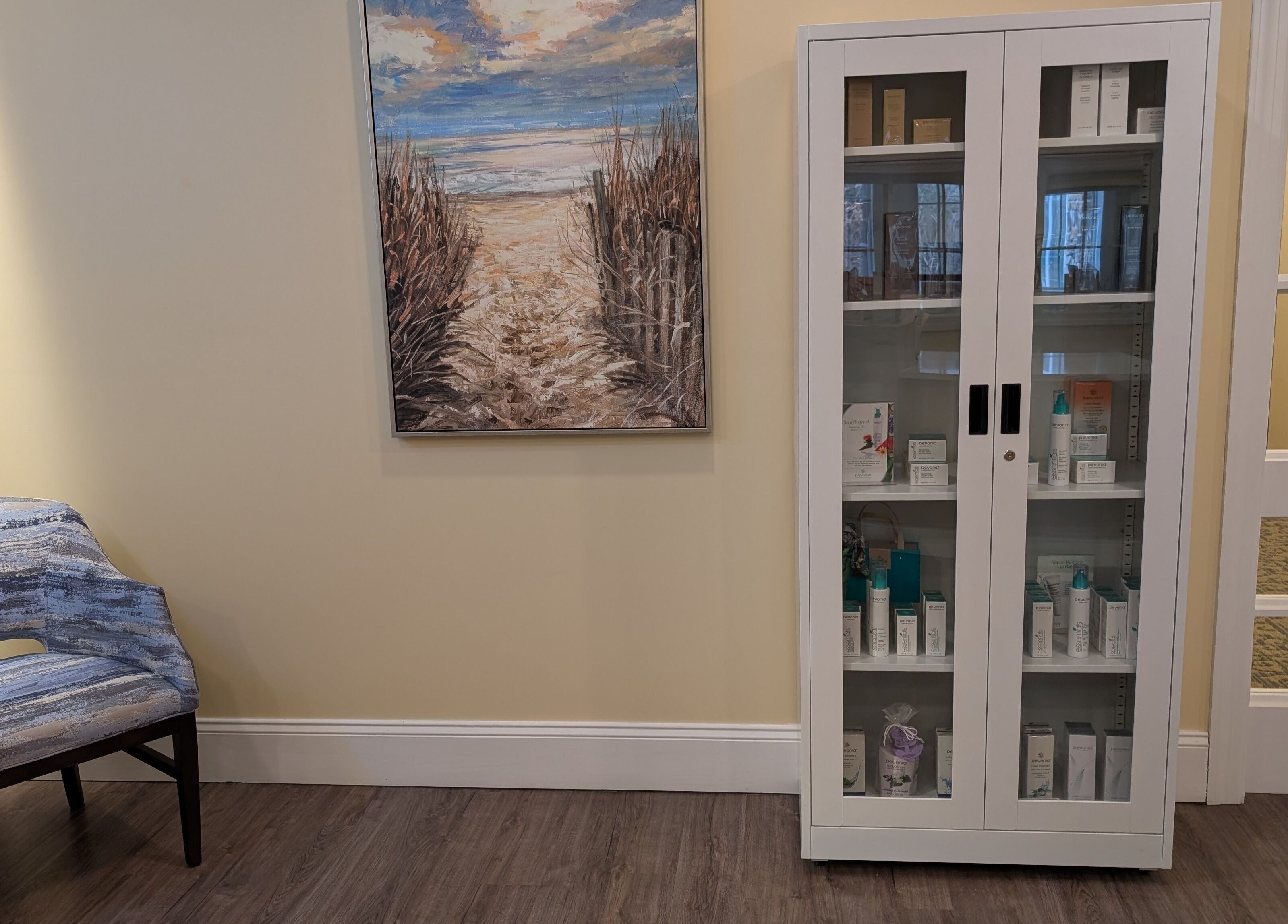Relaxing corner at The Spa at The Villas Holmdel, Holmdel, New Jersey, US with art and skincare display.