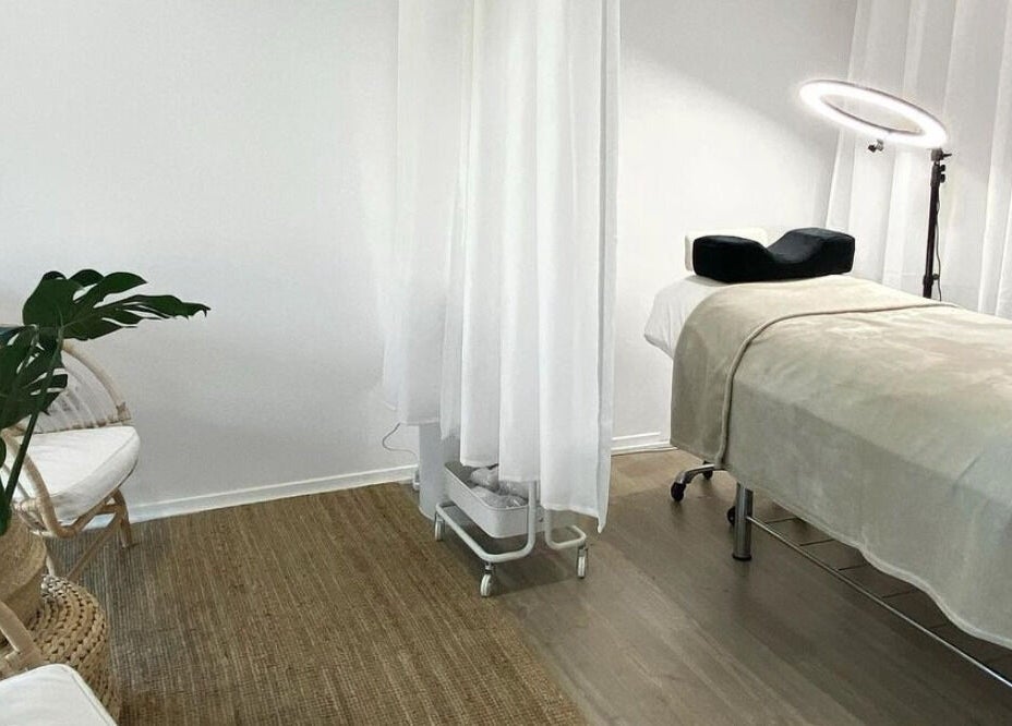 Relaxing treatment room at The Lash Cove, Meridan Plains, Queensland, AU. Modern decor with spa bed under soft lighting.