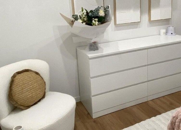 Elegant white chair and dresser at The Lash Cove, Meridan Plains, Queensland, AU, creating a serene ambiance.