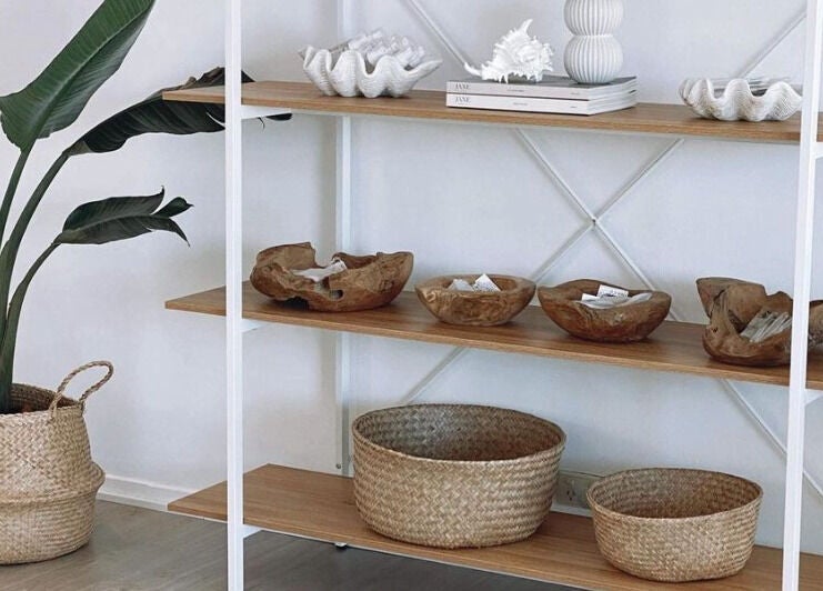 Minimalist decor at The Lash Cove, Meridan Plains, Queensland, AU, with natural baskets and tropical plant.