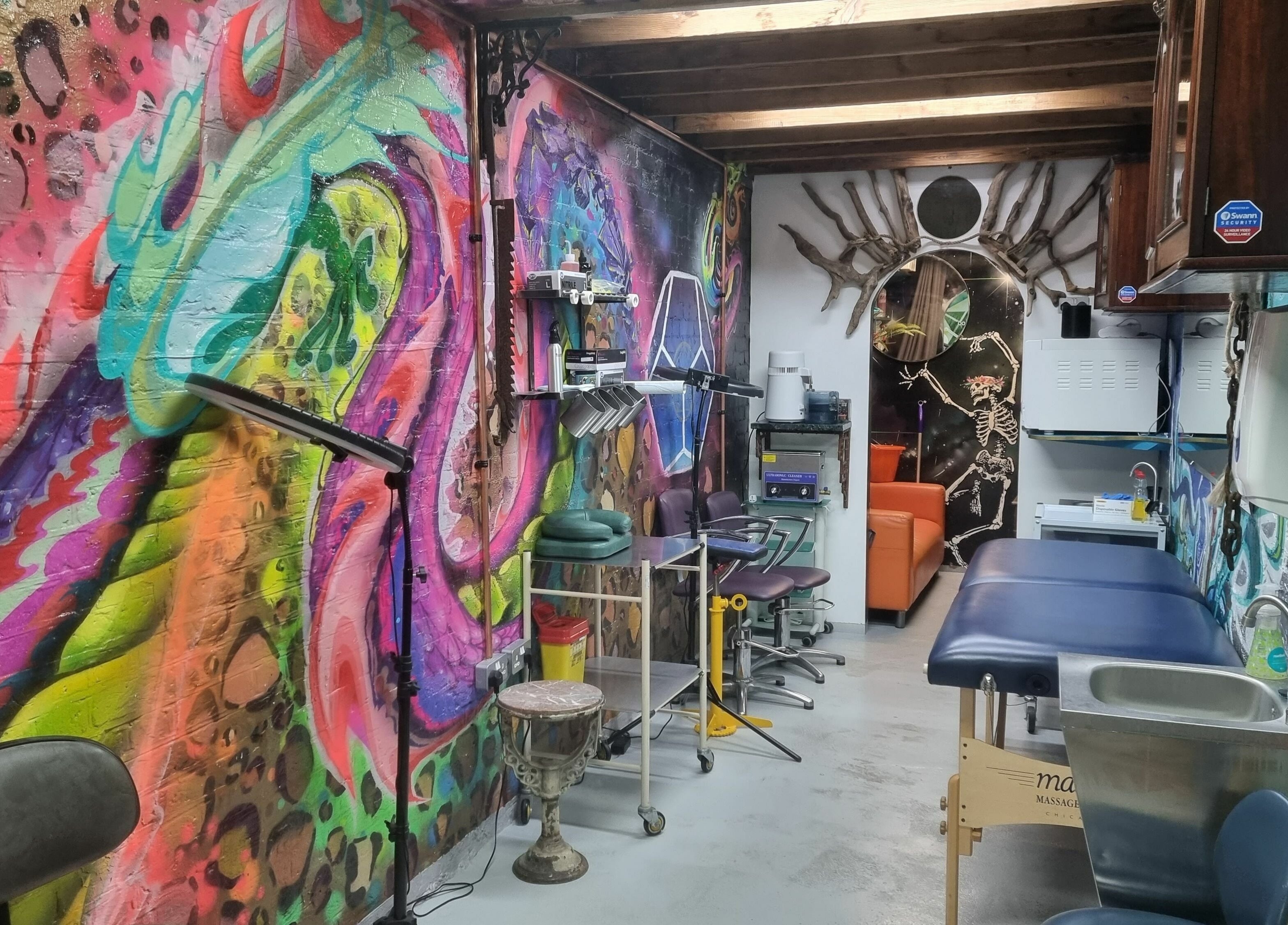 Colorful interior of Studio Gaia London, located in London, England, GB, showcasing vibrant graffiti art and wellness setup.