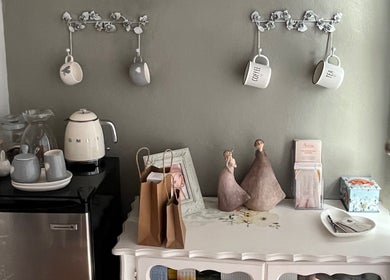 Charming refreshment area at The Skin Spot, Cape Town, Western Cape, ZA with mugs, a kettle, and décor.