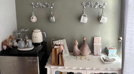 Charming refreshment area at The Skin Spot, Cape Town, Western Cape, ZA with mugs, a kettle, and décor.
