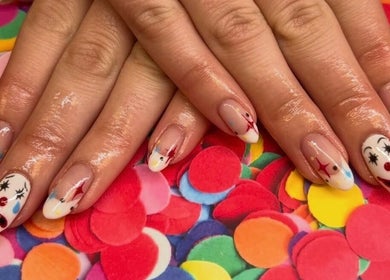 Clown-themed nail art at Kayley Diane Nails, Colchester, England, GB, over colorful confetti background.