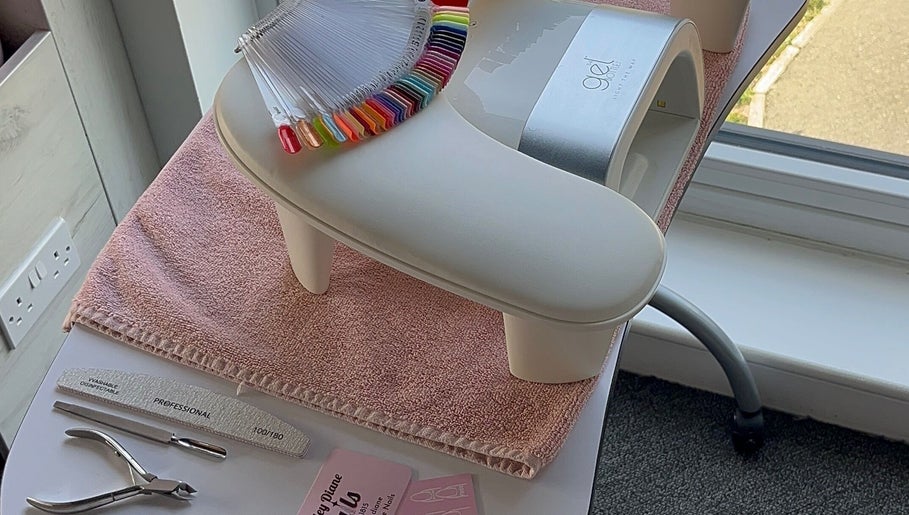 Kayley Diane Nails workstation in Colchester, England, GB showcasing nail colors and tools near a bright window.