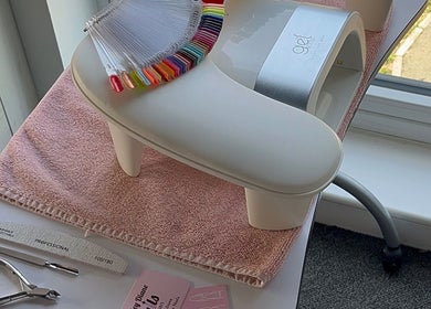 Kayley Diane Nails workstation in Colchester, England, GB showcasing nail colors and tools near a bright window.