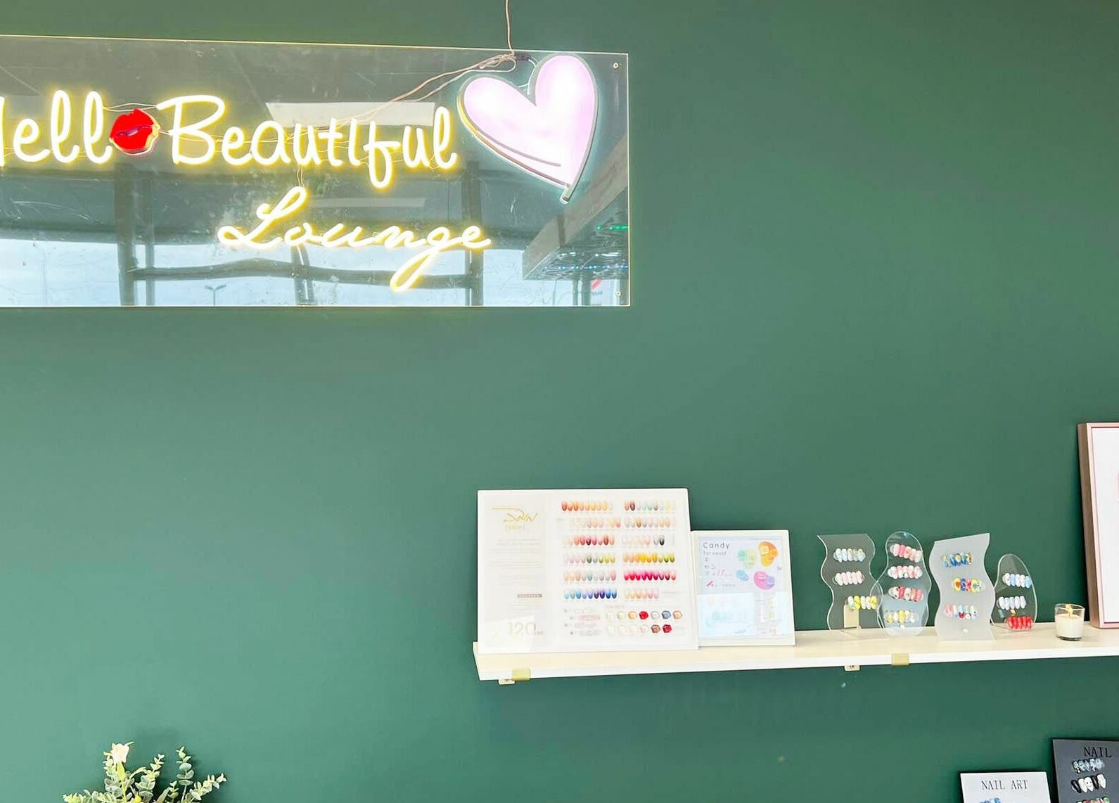 Stylish Hello Beautiful Lounge in Hastings, NZ showcasing vibrant nail designs and decor.