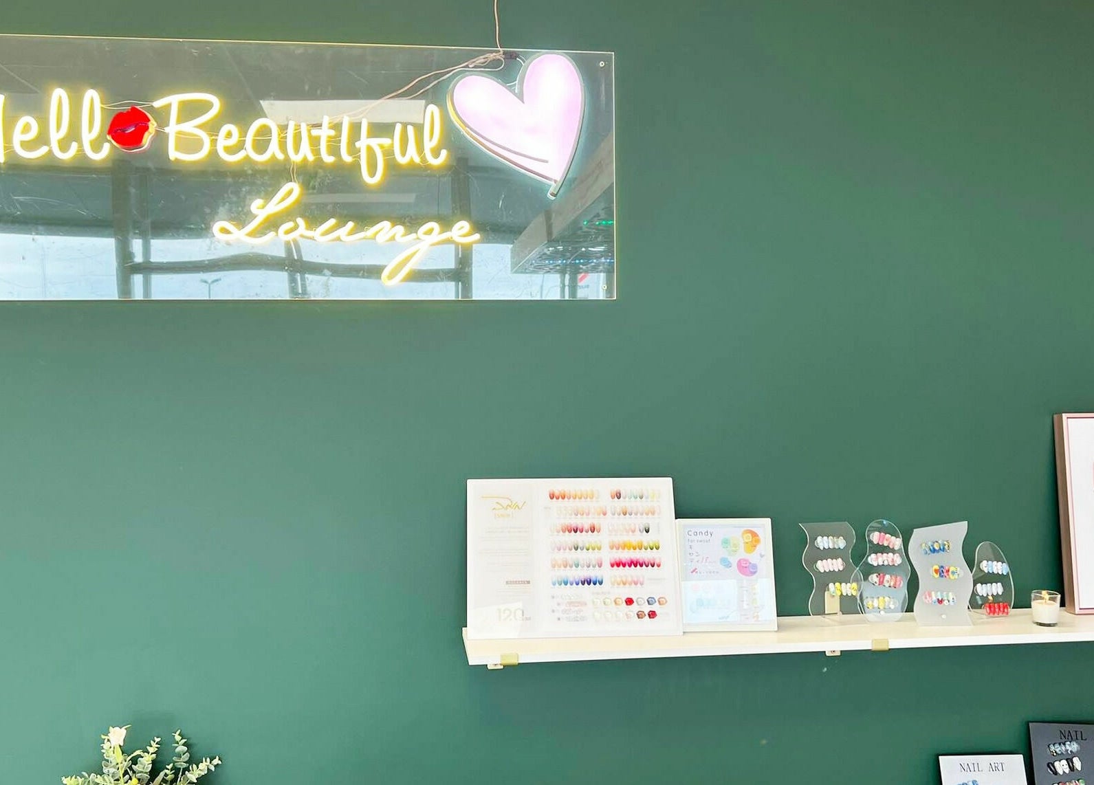 Stylish Hello Beautiful Lounge in Hastings, NZ showcasing vibrant nail designs and decor.