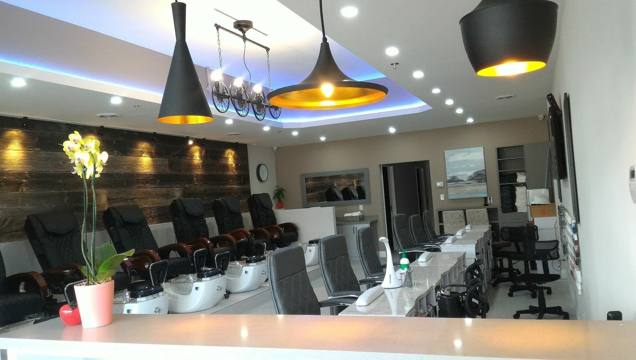 Modern interior of The Nail Chamber in Markham, Ontario, CA, showcasing comfortable seating and elegant lighting.