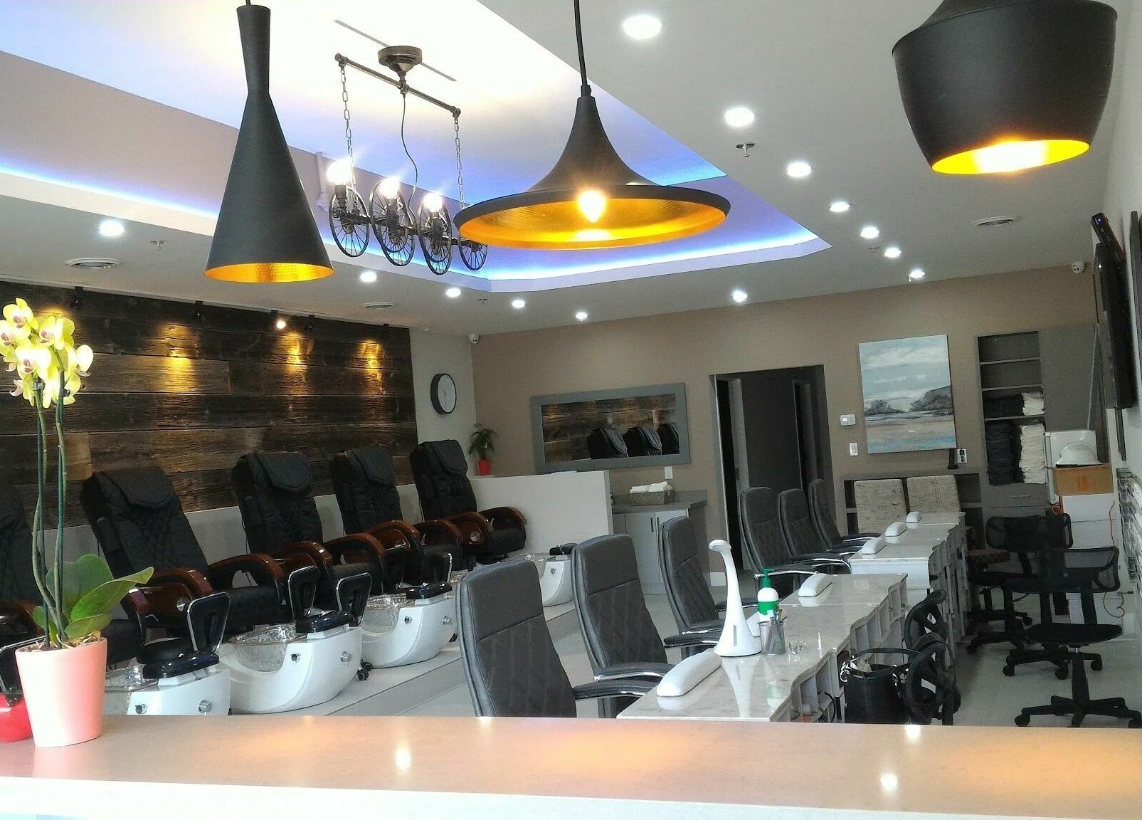 Modern interior of The Nail Chamber in Markham, Ontario, CA, showcasing comfortable seating and elegant lighting.