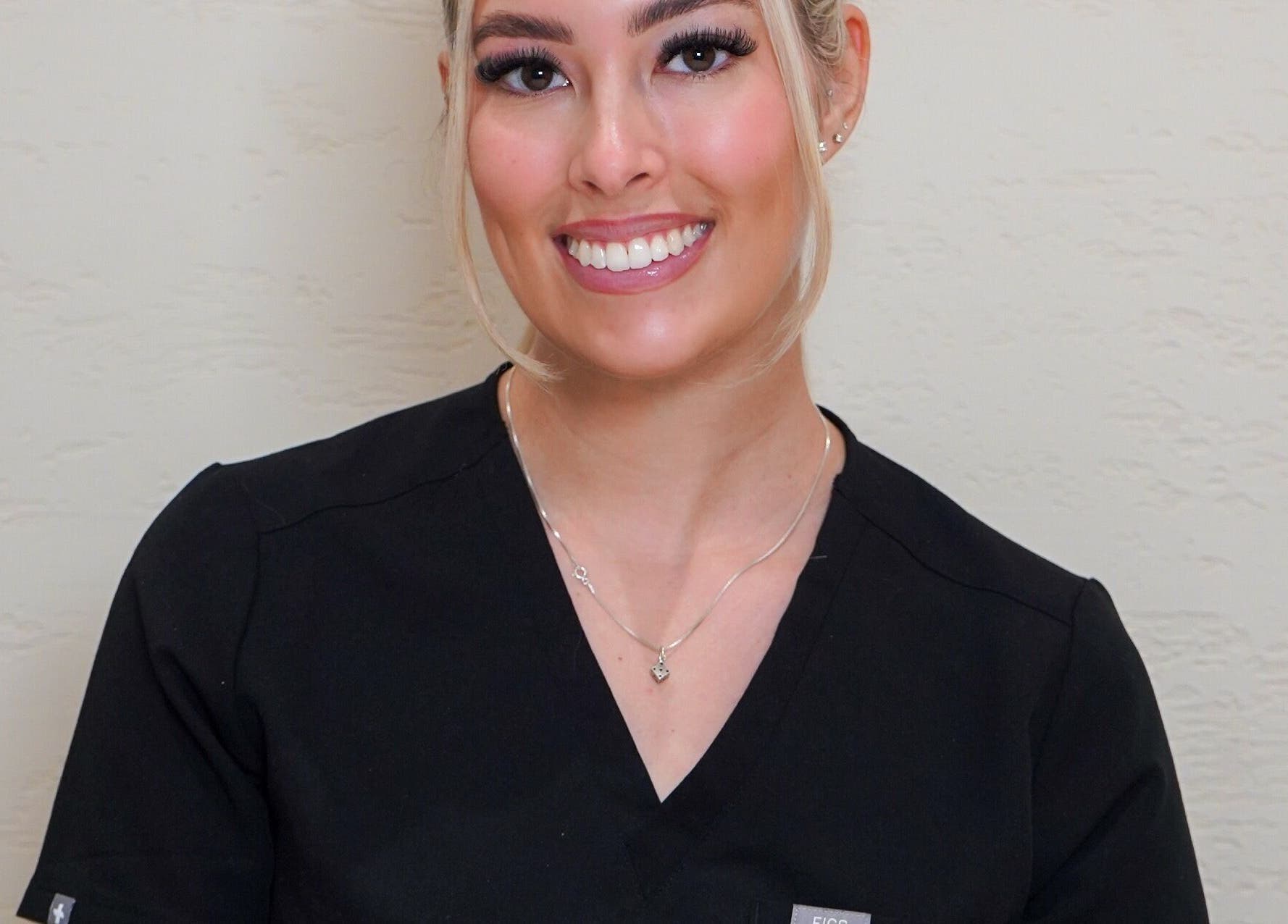 Smiling beauty professional at Angel Studio in Fetcham, England, GB, offering exceptional wellness services.