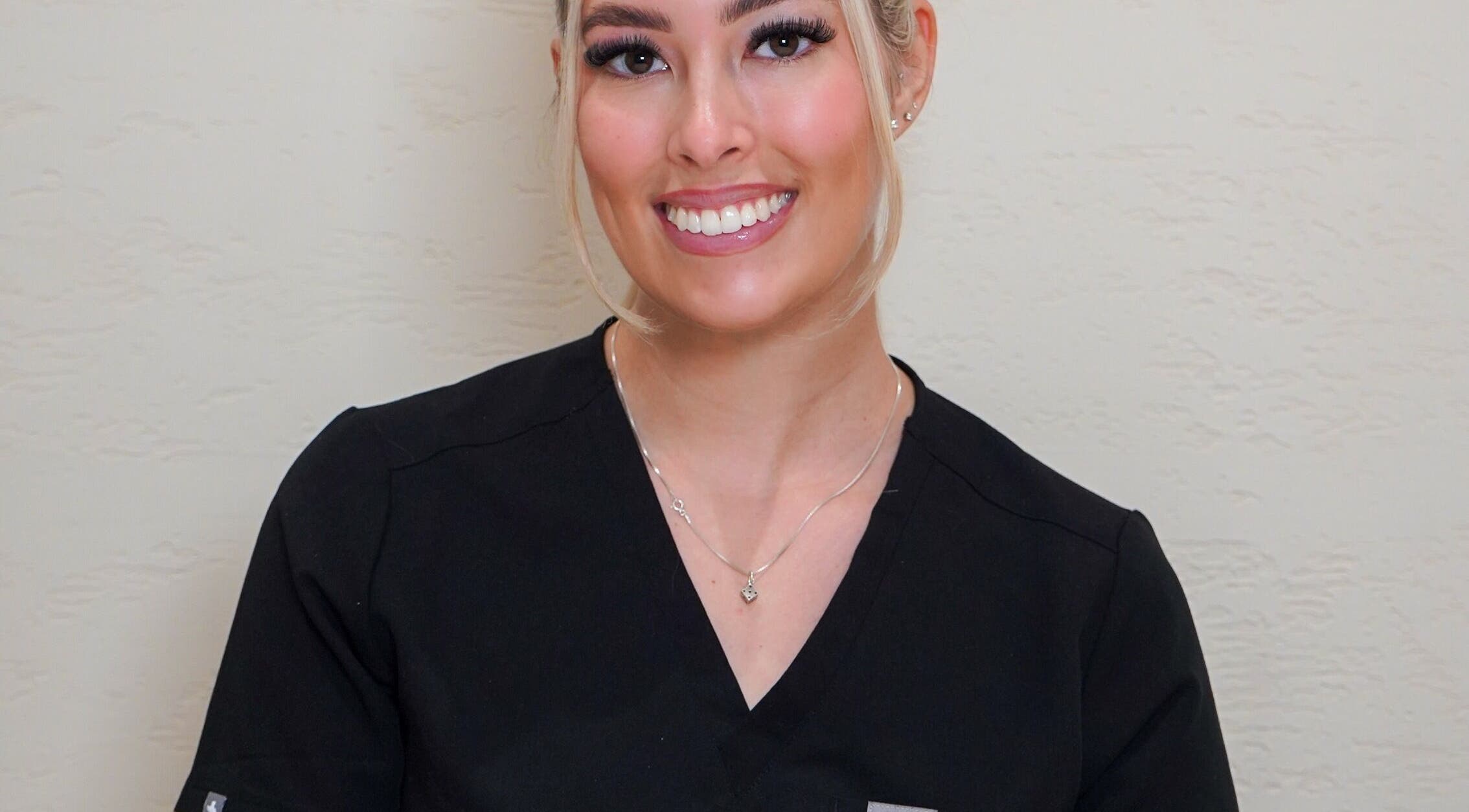 Smiling beauty professional at Angel Studio in Fetcham, England, GB, offering exceptional wellness services.