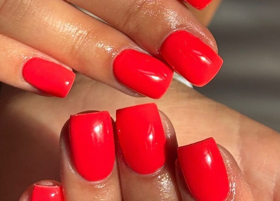 Bright red manicured nails at Angel Studio, Fetcham, England, GB showcasing elegant nail art design.