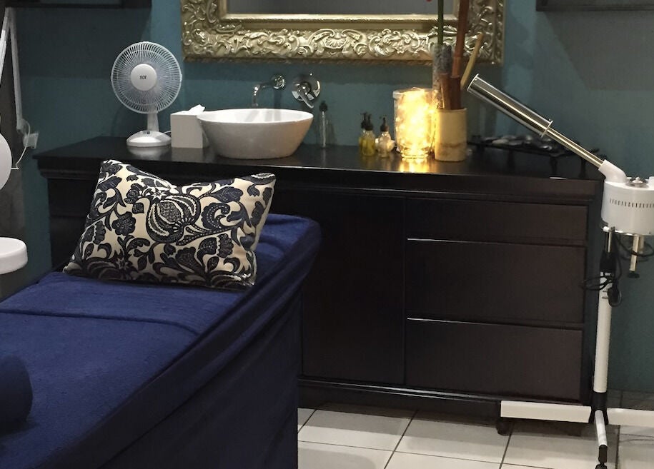 Relaxing treatment room at Sodwana Spa, Shazibe, KwaZulu-Natal, ZA with plush bed and elegant decor.