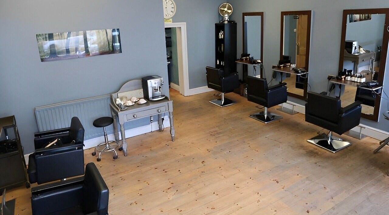 Modern interior of Suma hairdressing with sleek chairs and mirrors in DURHAM, England, GB.