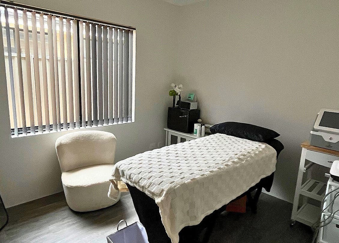 Cozy treatment room at Gods Work Studio, Hilbert, Western Australia, AU with massage bed and seating.
