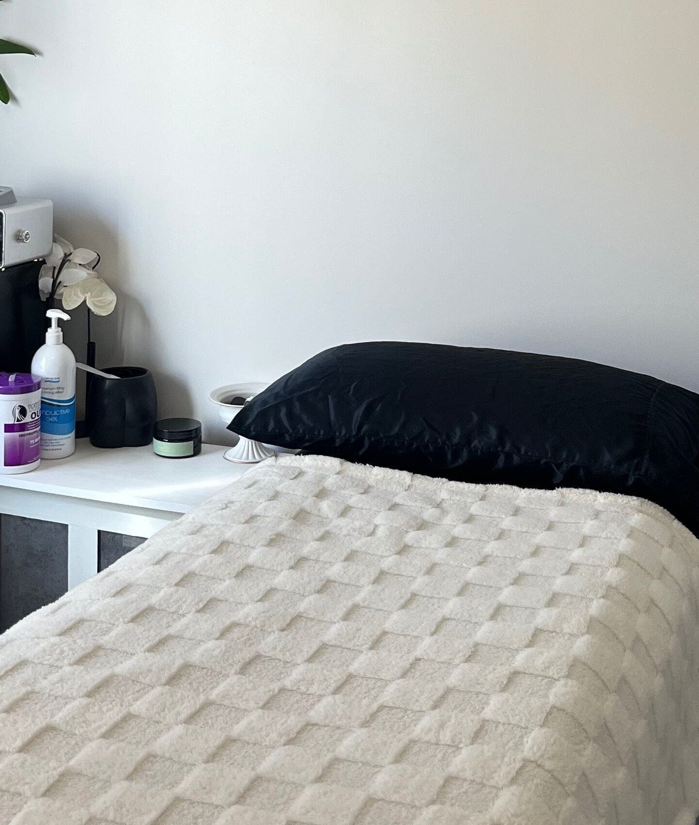 Relaxing treatment room at Gods Work Studio, Hilbert, Western Australia, AU with a cozy bed setup.