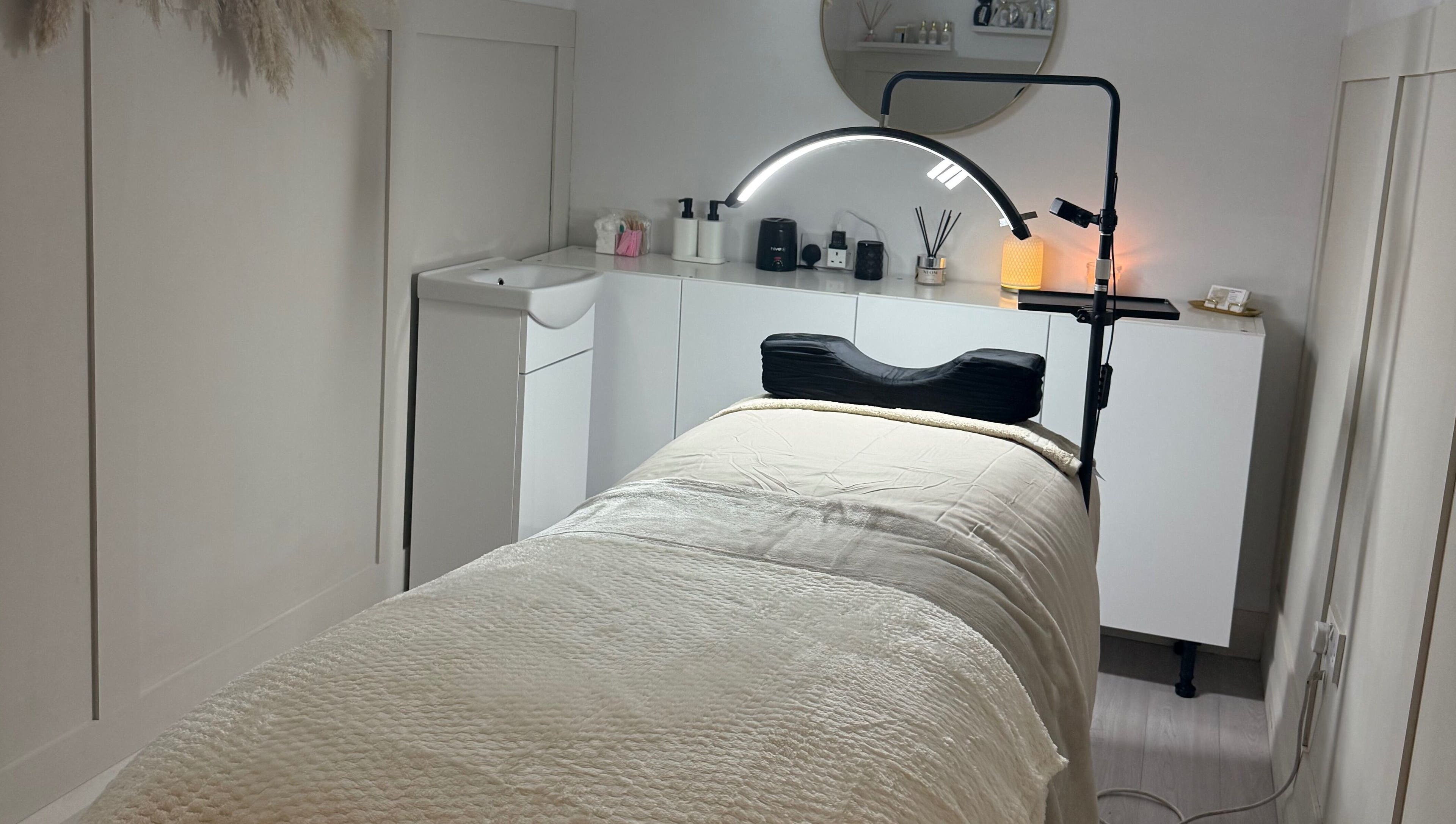 Cozy treatment room at Belles Beauty in Mirfield, England, GB featuring a massage bed and calm atmosphere.