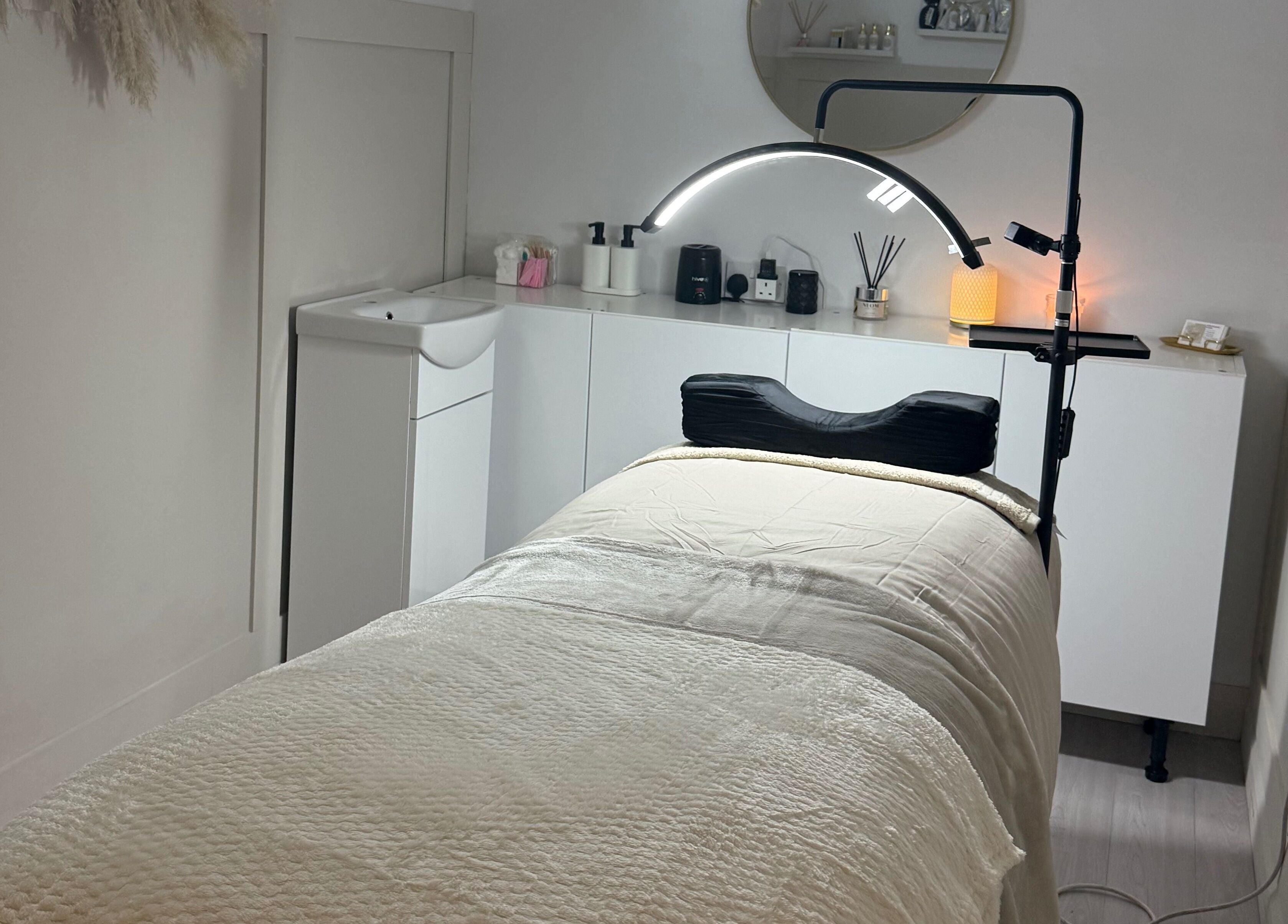 Cozy treatment room at Belles Beauty in Mirfield, England, GB featuring a massage bed and calm atmosphere.