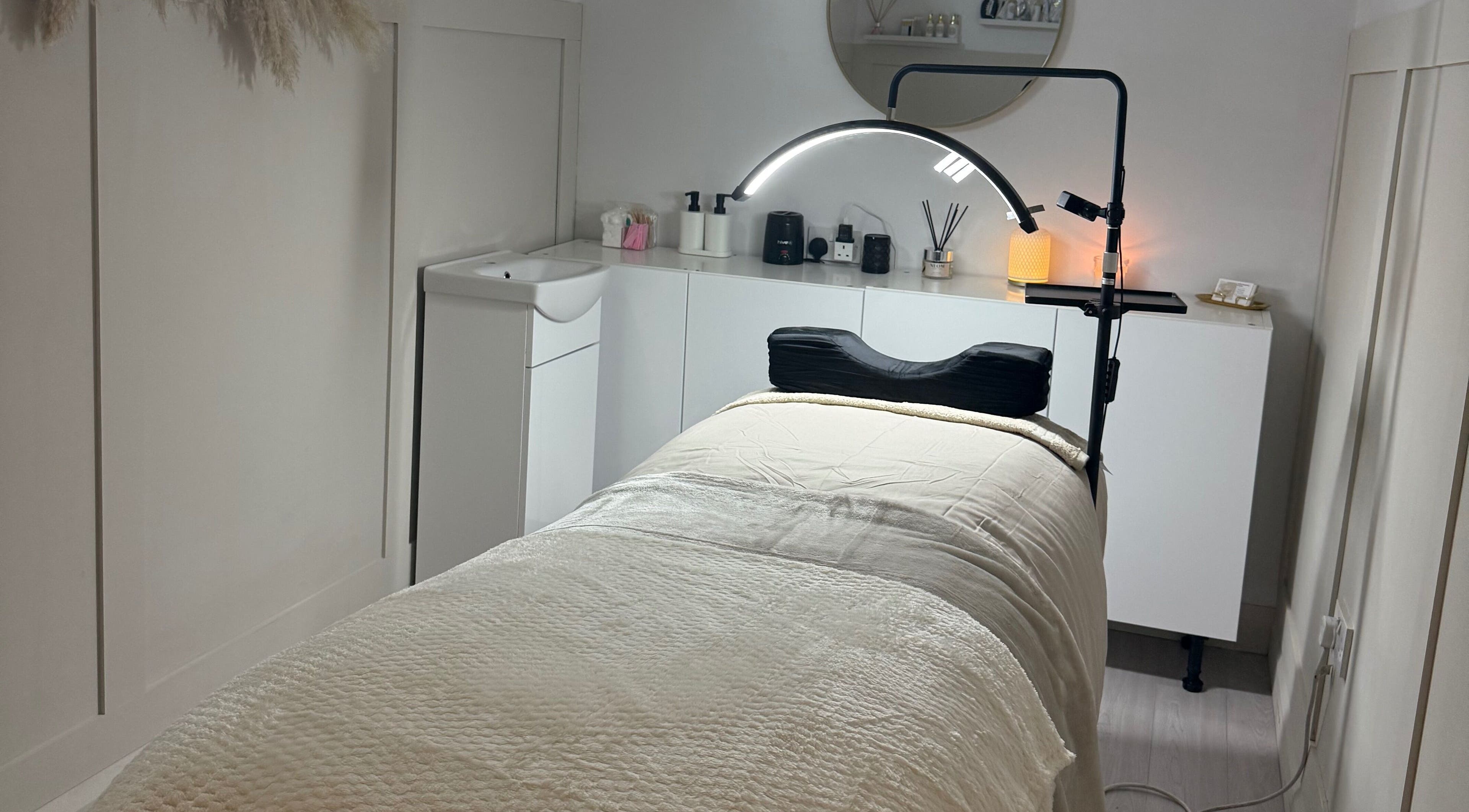 Cozy treatment room at Belles Beauty in Mirfield, England, GB featuring a massage bed and calm atmosphere.