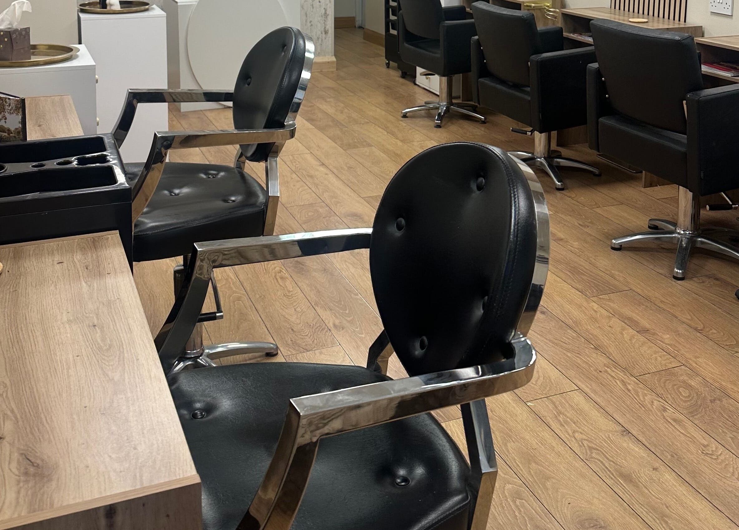 Modern salon chairs at Belles Beauty, Mirfield, England, GB showcasing sleek interior design.