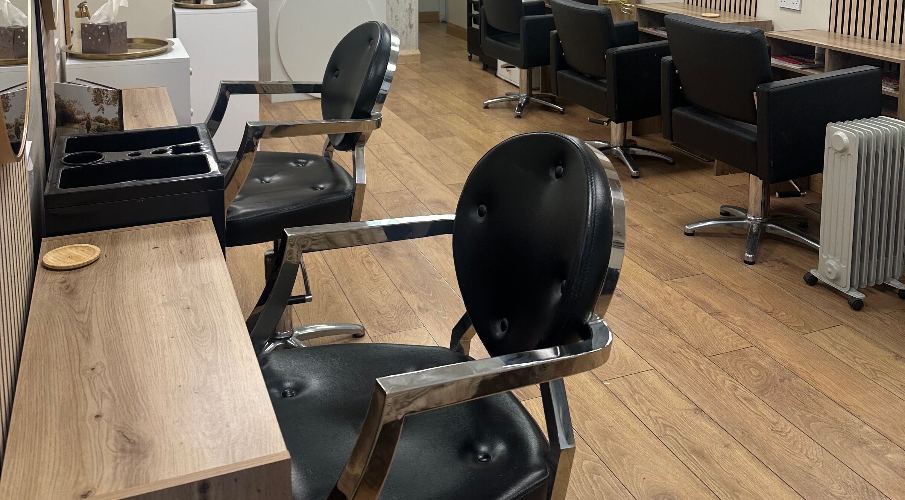 Modern salon chairs at Belles Beauty, Mirfield, England, GB showcasing sleek interior design.