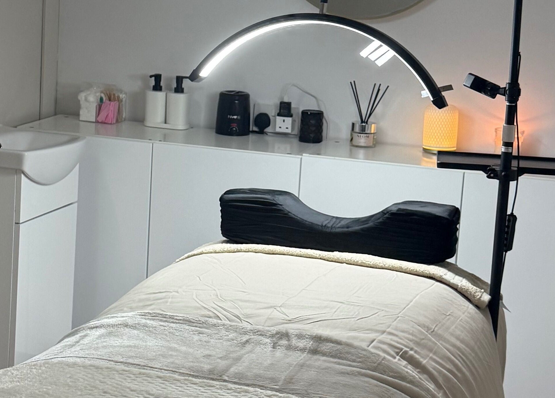 Relaxing treatment room at Belles Beauty, Mirfield, England, GB with massage table and ambient lighting.