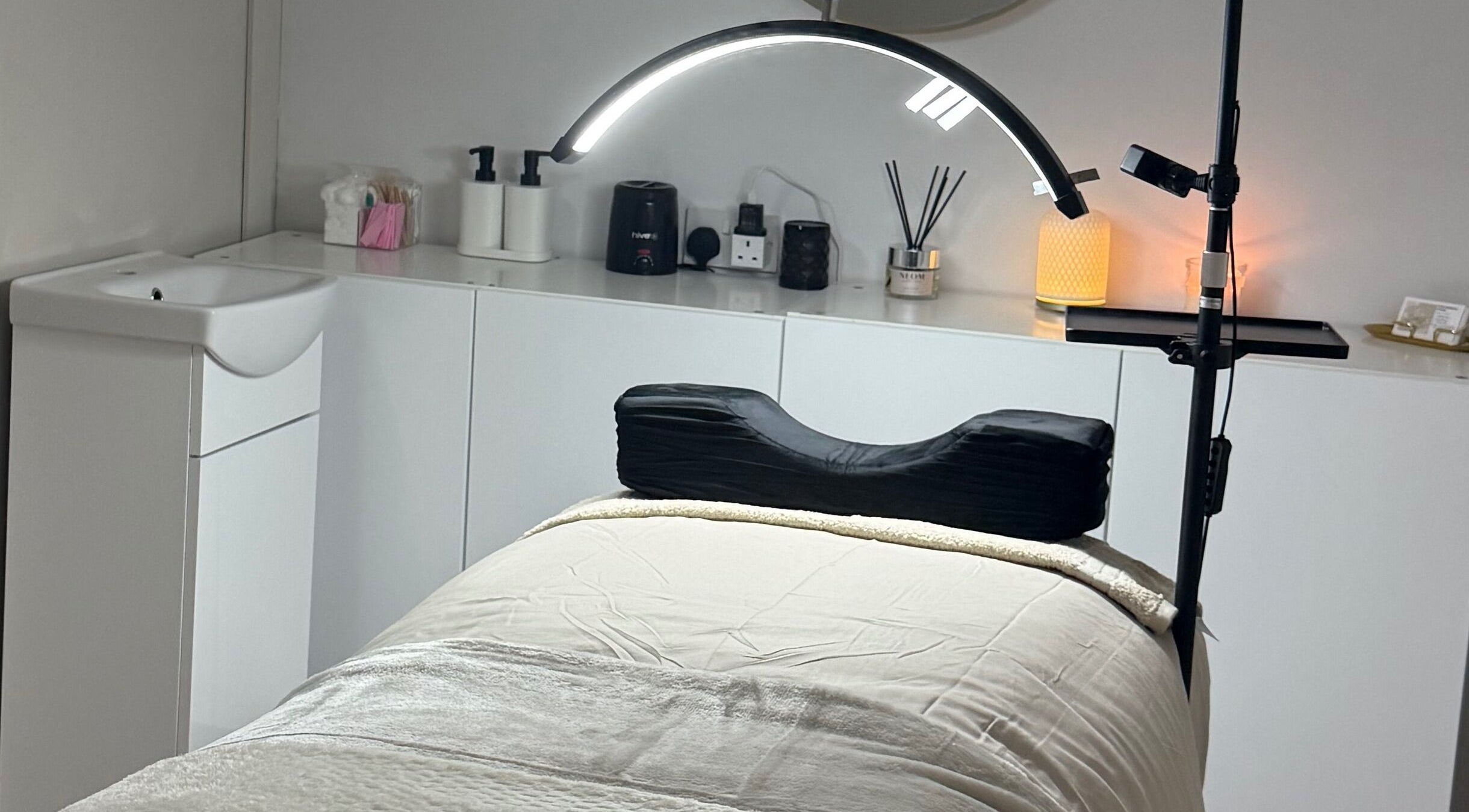 Relaxing treatment room at Belles Beauty, Mirfield, England, GB with massage table and ambient lighting.