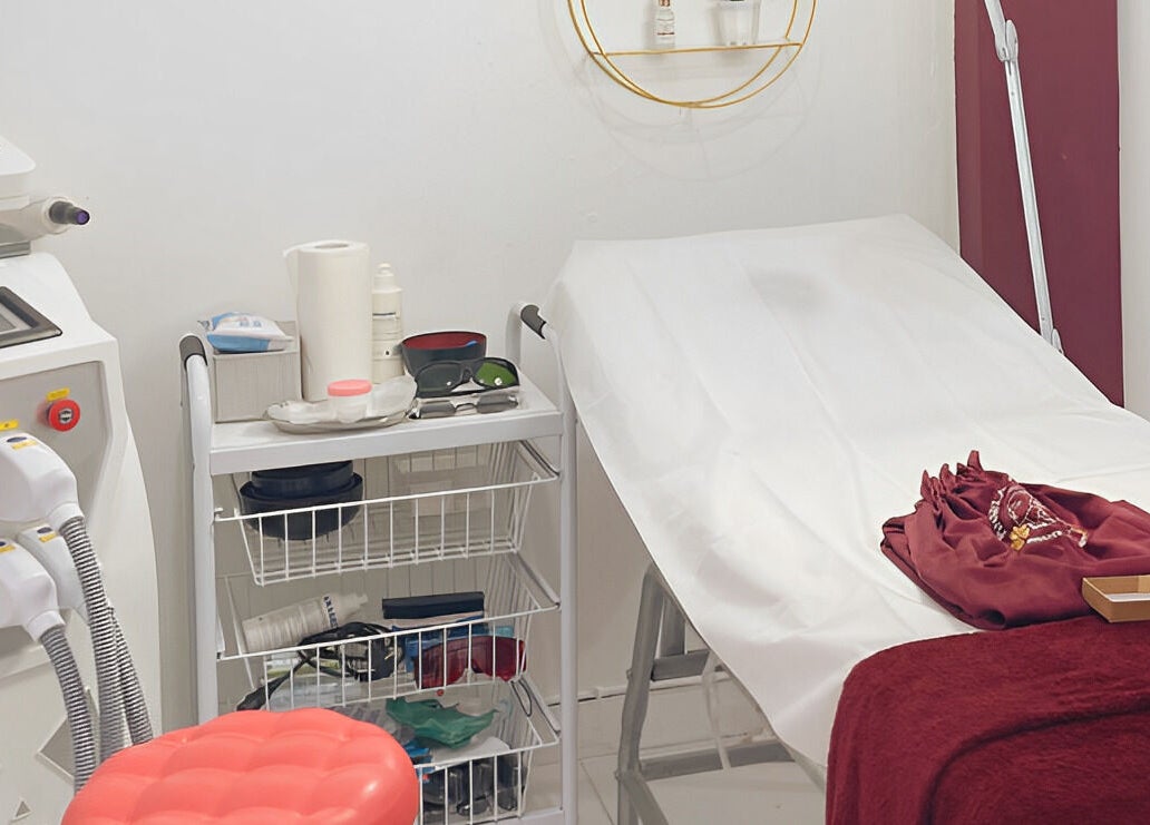 Treatment room at Pinsela Aesthetic in Bali, Bali, ID, featuring a clean bed and advanced skincare equipment.
