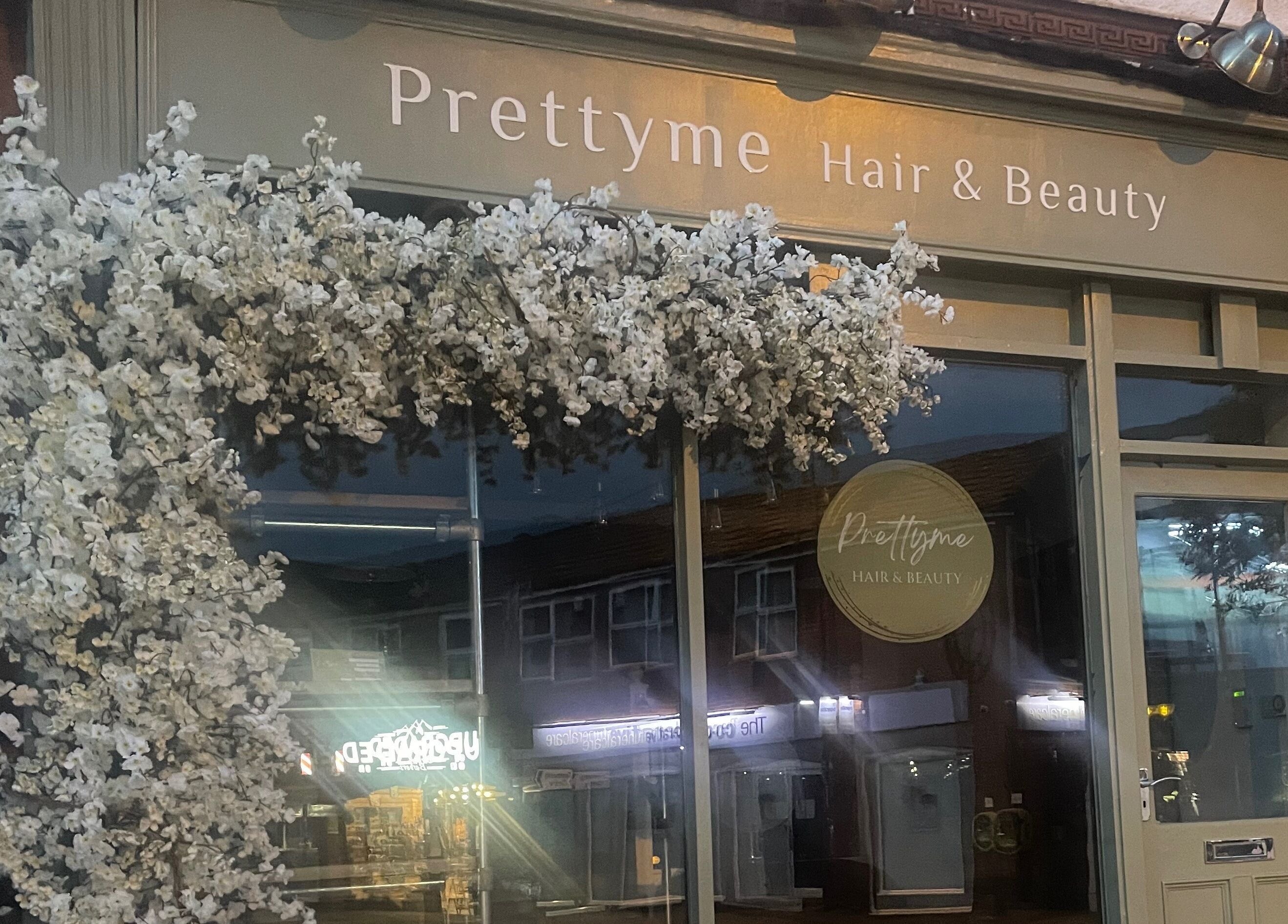 Prettyme Hair and Beauty's elegant facade in Derby, England, GB, adorned with white blossoms.