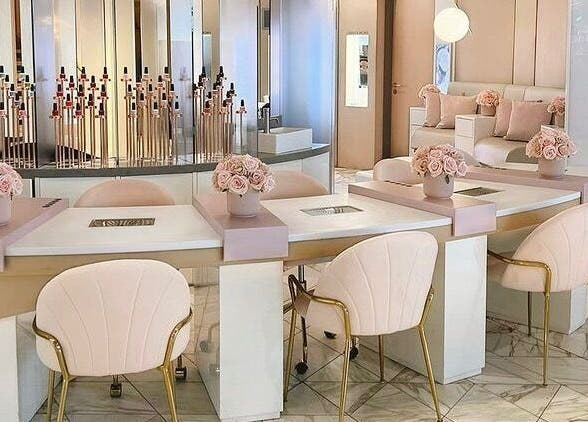 Elegant nail salon interior at Nail'd It Birmingham, Birmingham, England, GB featuring plush chairs and chic decor.