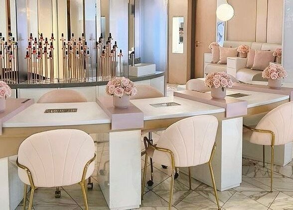 Elegant nail salon interior at Nail'd It Birmingham, Birmingham, England, GB featuring plush chairs and chic decor.