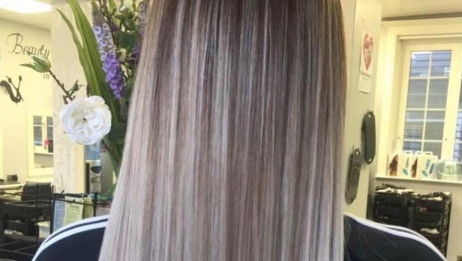Smooth straight hairstyle at Hair By Lorna Oldroyd, Ossett, England, GB with a floral backdrop.