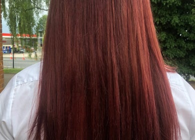Vibrant red hair styled by Hair By Lorna Oldroyd at Ossett, England, GB.