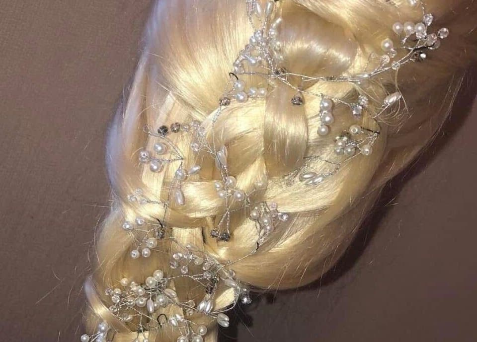 Intricate pearl-adorned braid hairstyle at Hair By Lorna Oldroyd in Ossett, England, GB.