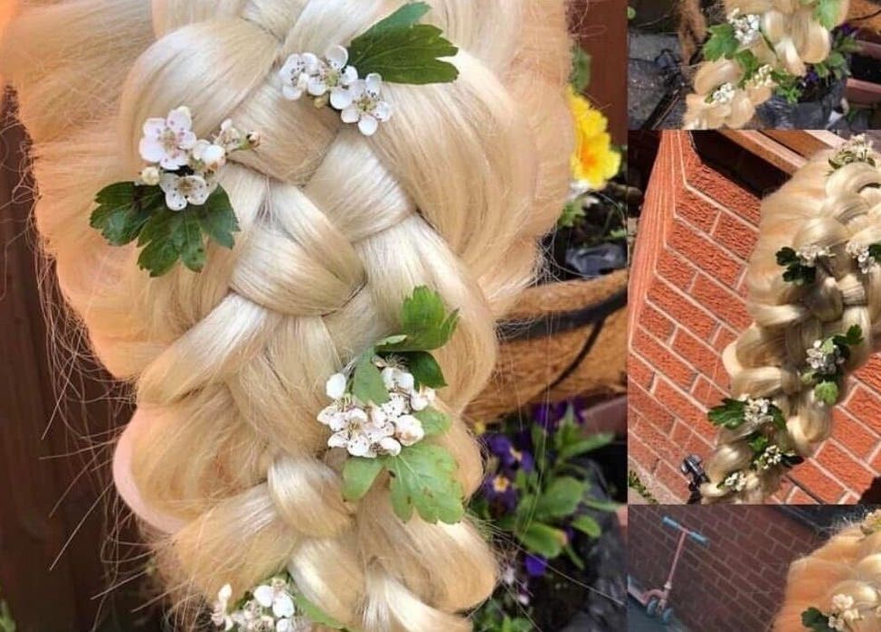 Intricate blonde braid adorned with flowers at Hair By Lorna Oldroyd, Ossett, England, GB.