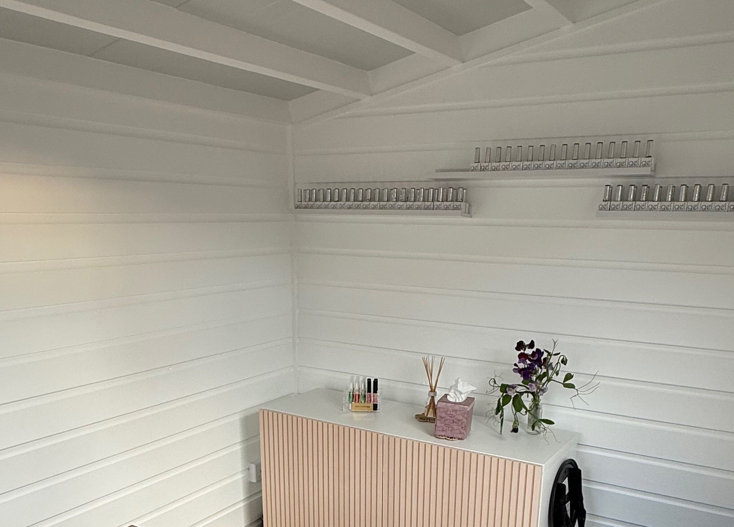 Elegant nail studio corner at Nails by Rachel, Aberdeen, Scotland, GB showcasing organized polish display.