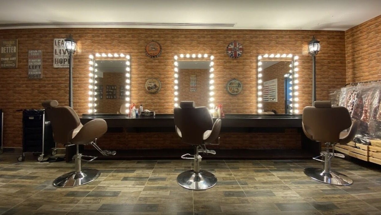 Elegant salon chairs and mirrors at Glam Street DMCC, Dubai, AE, showcasing a stylish beauty space.