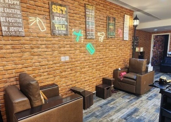 Cozy wellness lounge at Glam Street DMCC, Dubai, AE with stylish brick walls and modern seating.