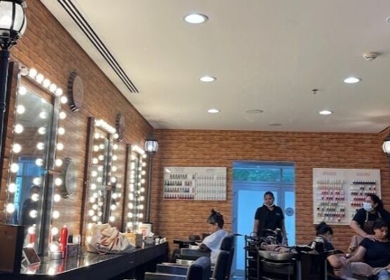 Elegant salon setup at Glam Street DMCC, Dubai, AE, featuring styling stations and vibrant decor.