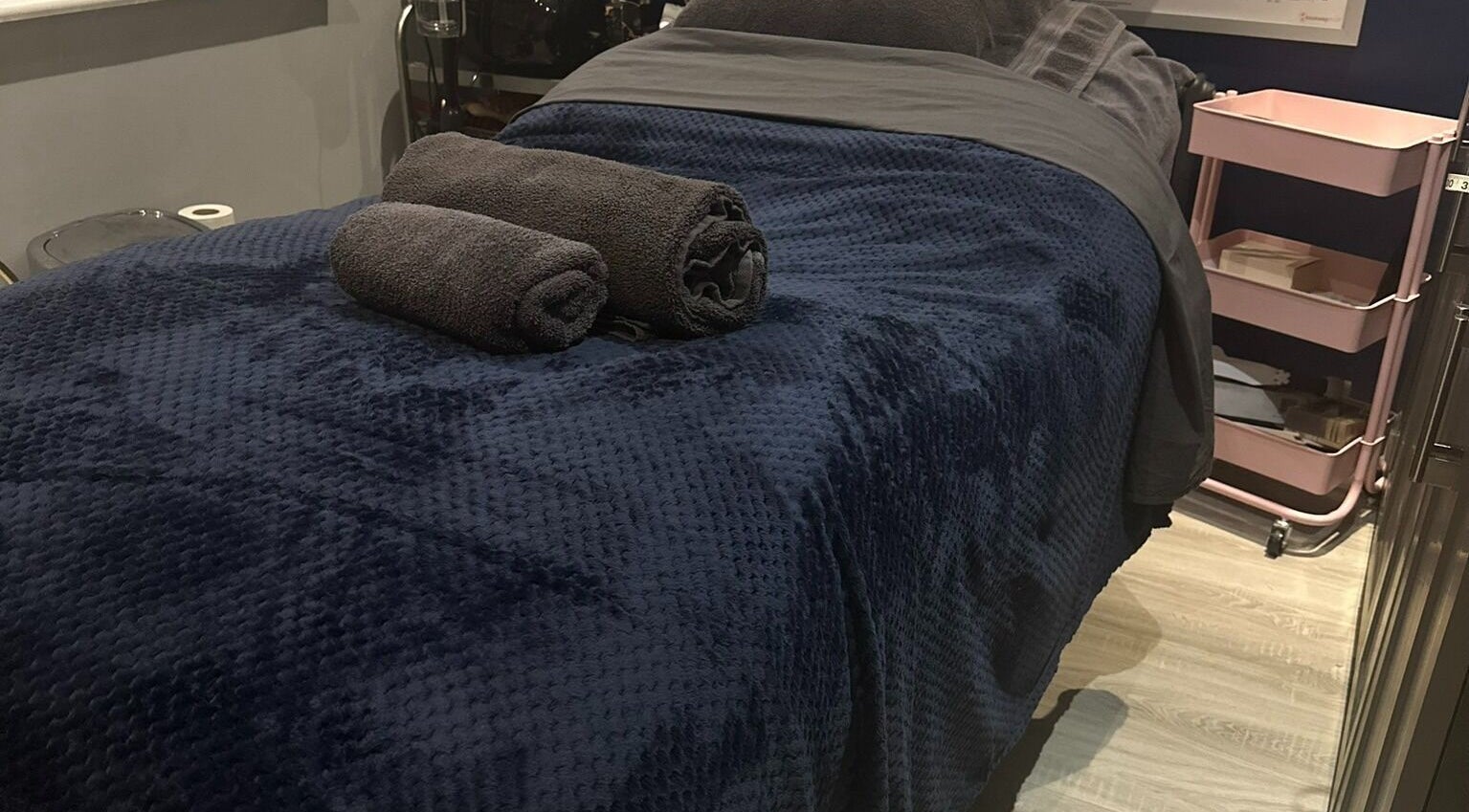 Luxurious treatment room at AU Naked Clinic, Telford, England, GB with plush towels and a cozy atmosphere.