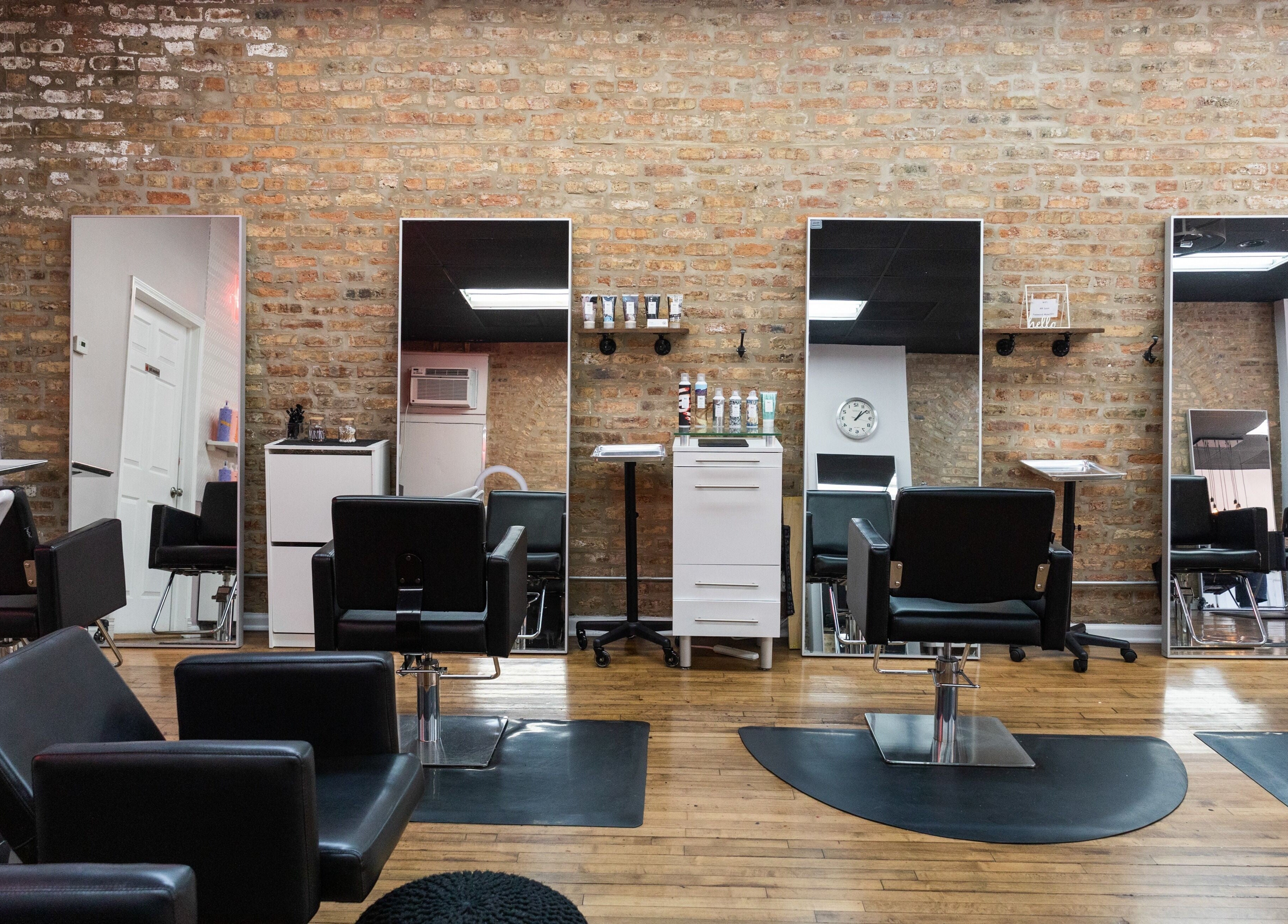 Modern interior of Mane Refinery Salon in Chicago, IL, US, featuring stylish styling chairs and large mirrors.