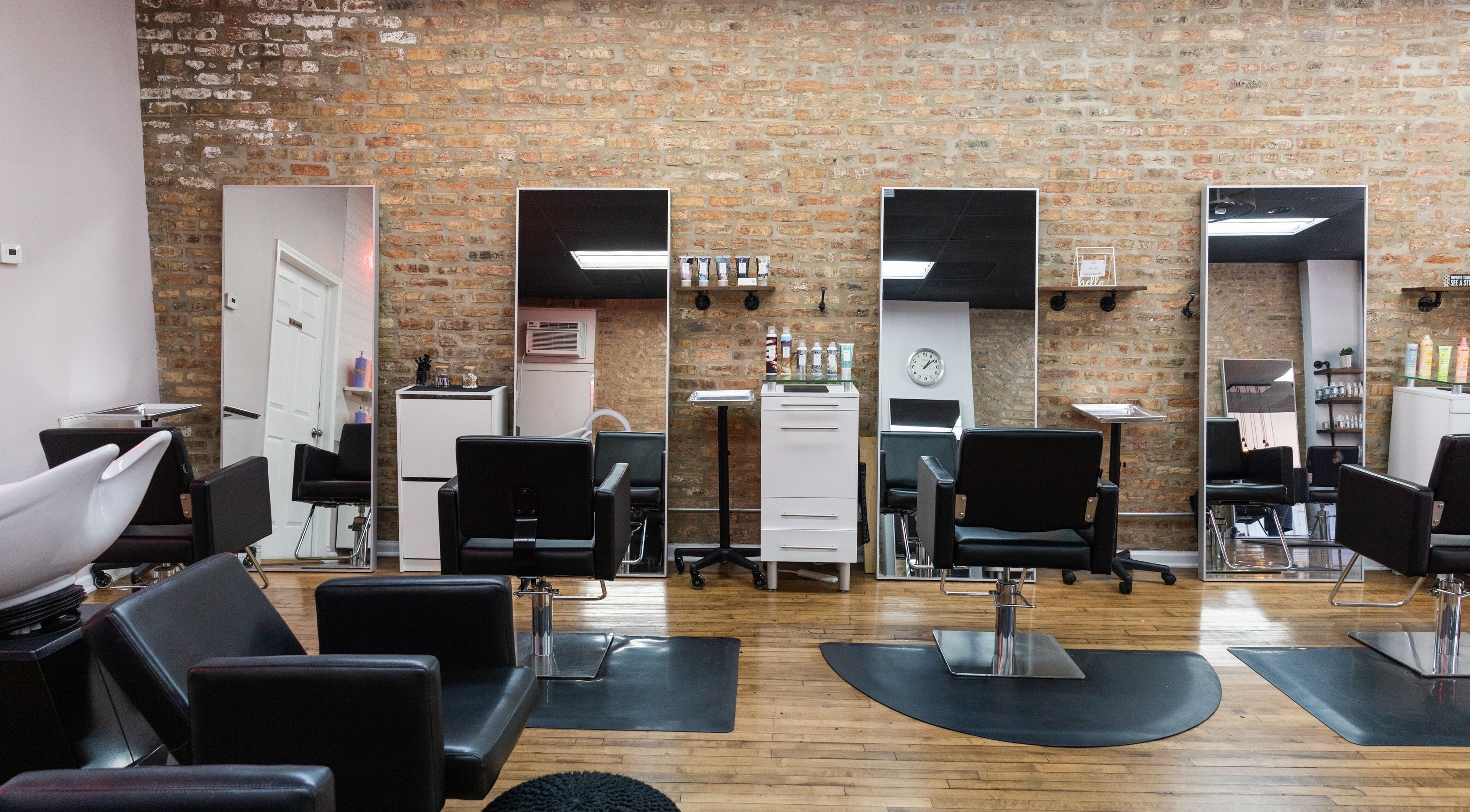 Modern interior of Mane Refinery Salon in Chicago, IL, US, featuring stylish styling chairs and large mirrors.