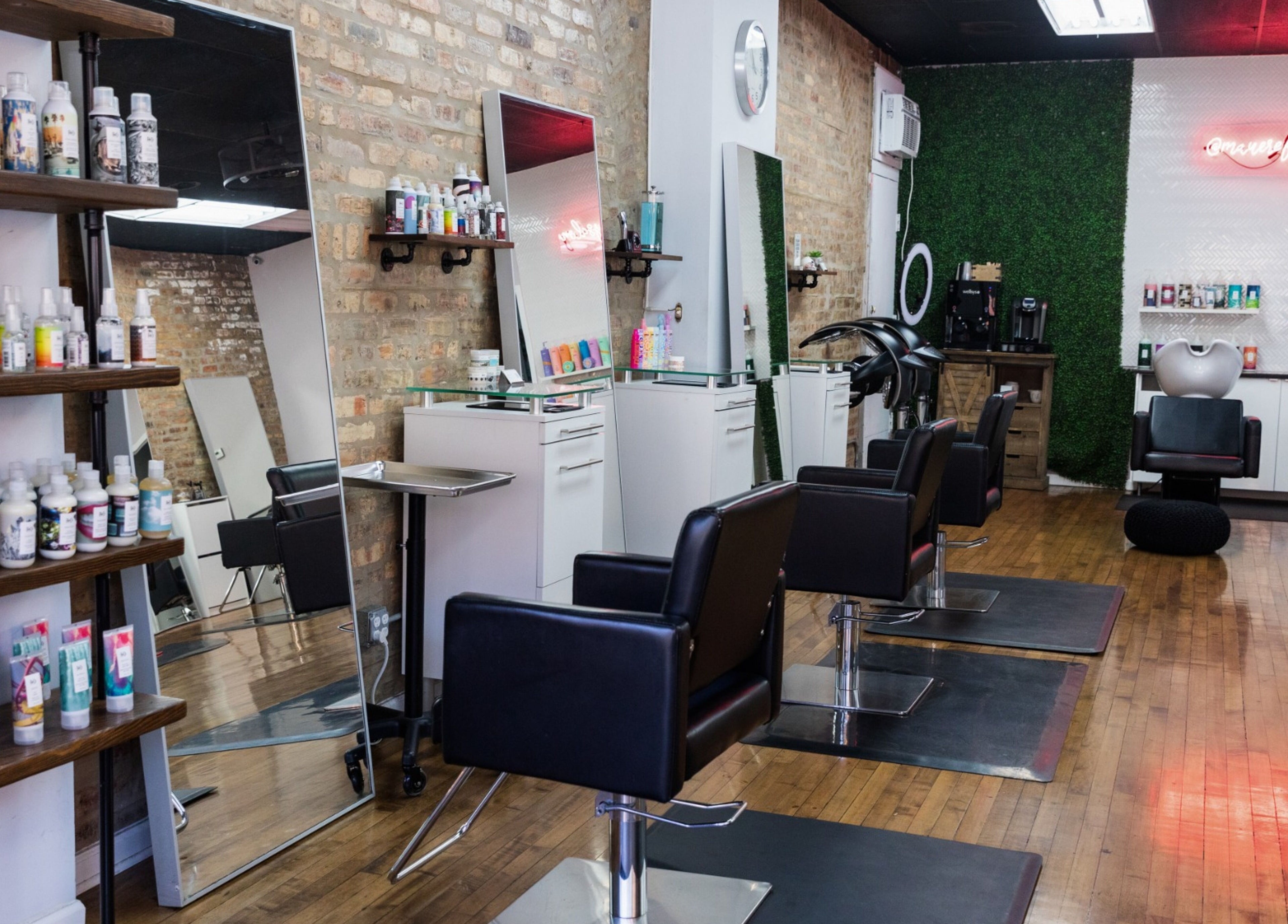 Modern interior of Mane Refinery Salon, Chicago, IL, US, featuring stylish chairs and hair products.