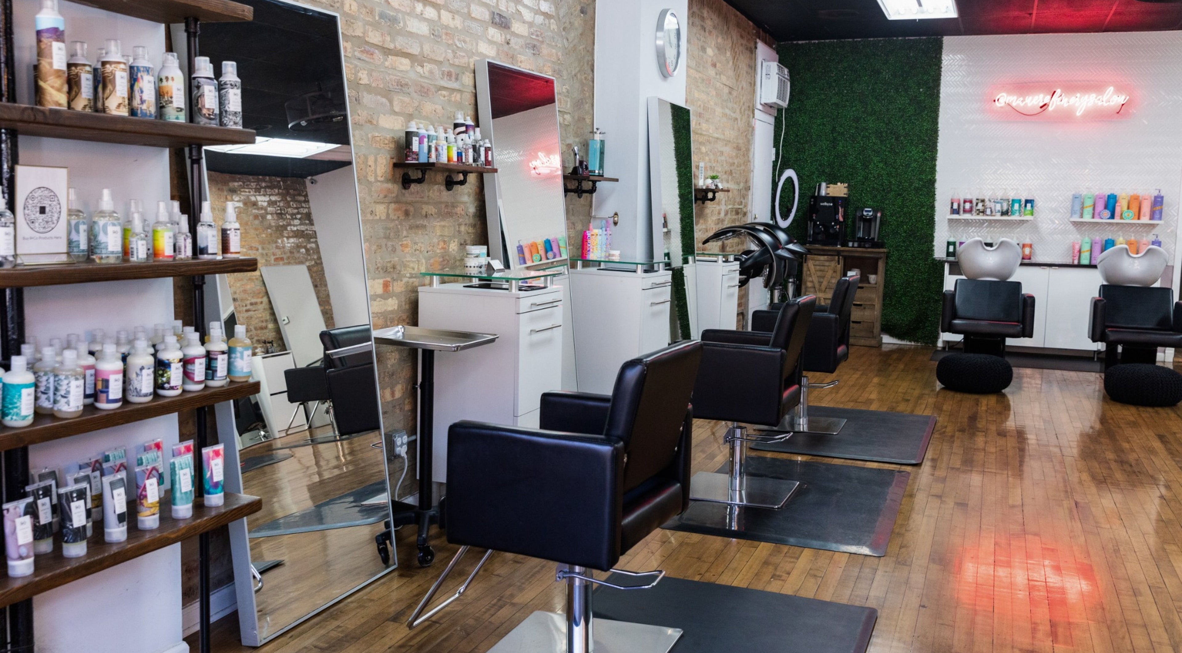 Modern interior of Mane Refinery Salon, Chicago, IL, US, featuring stylish chairs and hair products.